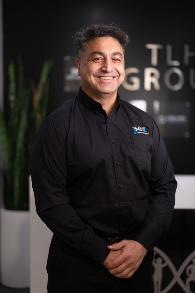 James Marroun from TLH Group smiling confidently in a professional setting, showcasing his expertise and leadership.