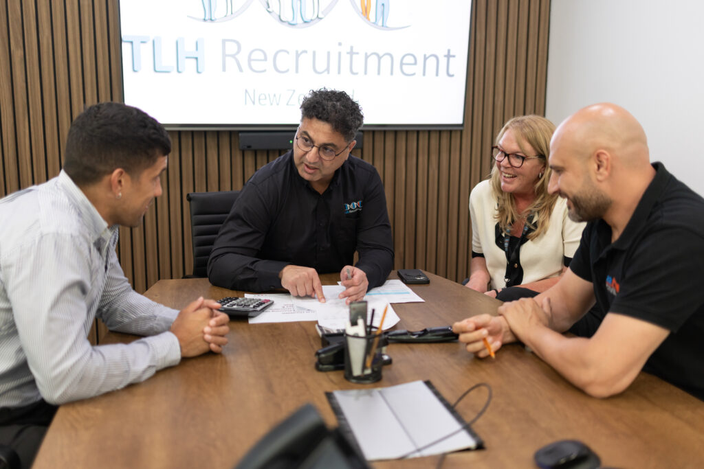 James Marroun leads a meeting at TLH Group, discussing recruitment strategies with team members in New Zealand.