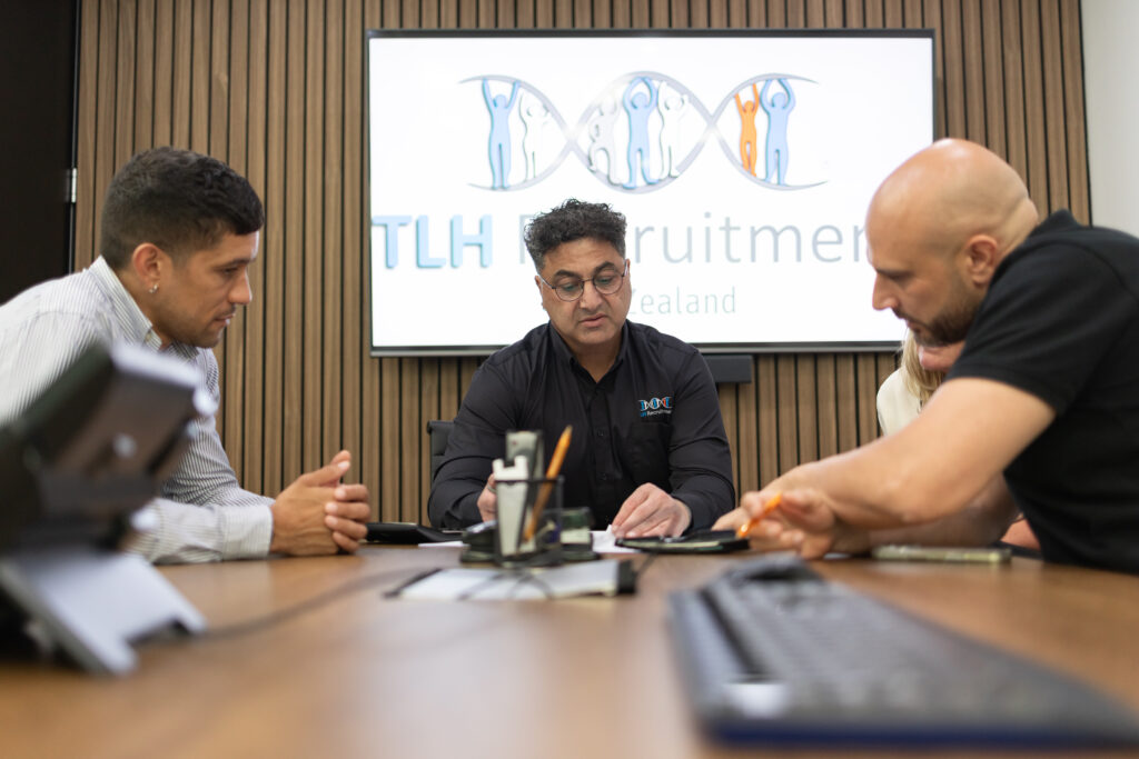 James Marroun leads a meeting at TLH Group, discussing recruitment strategies with team members.