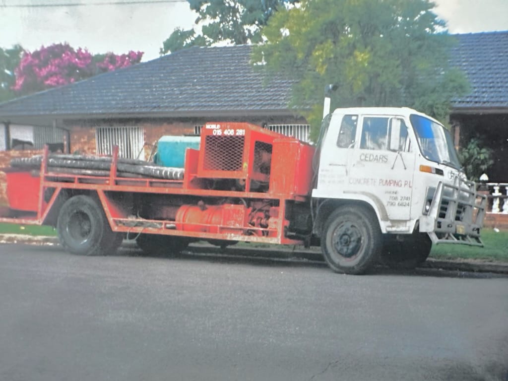 A concrete pumping truck from TLH Group, showcasing equipment for construction projects, emphasising quality service by James Marroun.
