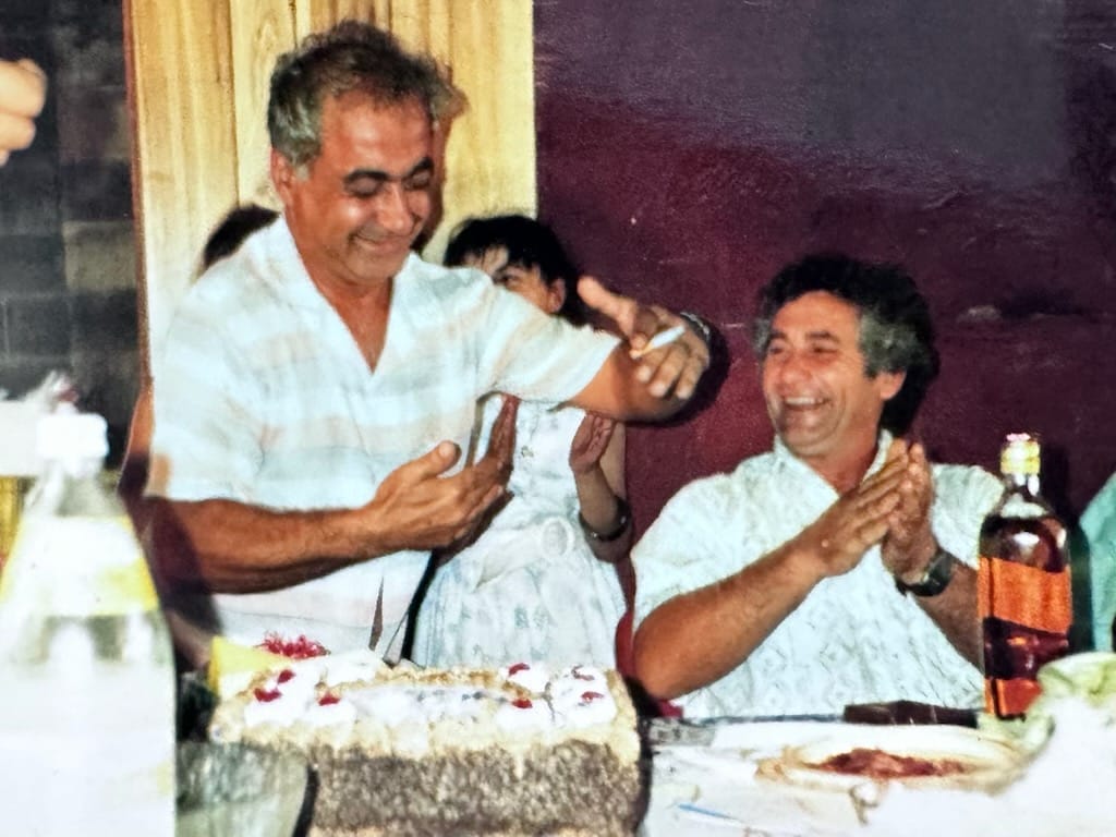 Celebration scene featuring joyful men at a gathering, possibly related to James Marroun and TLH Group.